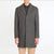 Man wearing a gray overcoat on a white background