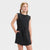 Young girl wearing a black sleeveless dress on a white background