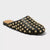 A black leather mule sandal covered in gold-tone metal studs, shown from a three-quarters angle on a light gray background.