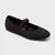 A single black knit Mary Jane flat shoe with a textured knit upper and a wide elastic strap across the top, shown on a light gray background.