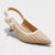 Beige pointed-toe shoe with woven pattern and white slingback design on a light gray background