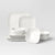 A white ceramic dinnerware set with square plates and matching bowls, arranged on a light gray studio background.