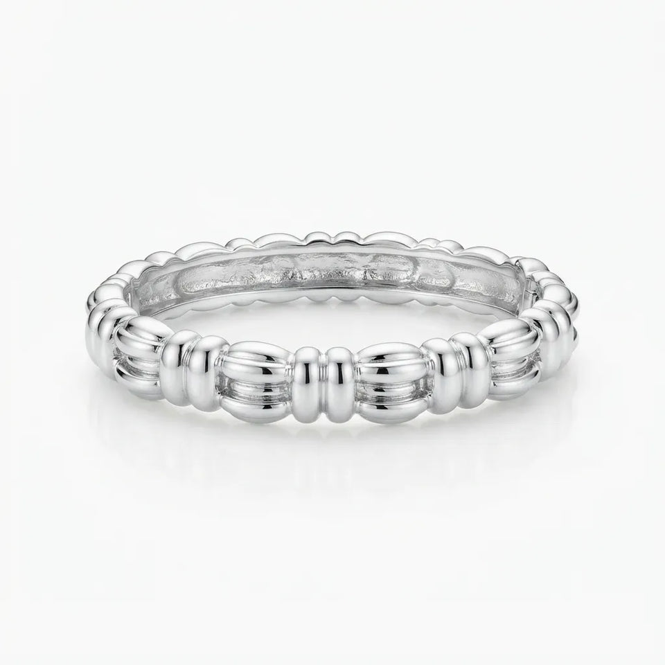 A polished silver eternity band ring with a textured, beaded exterior and a smooth, scalloped interior, shown on a clean white background.