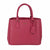 A pink faux-leather handbag with a polka-dot pattern, featuring dual top handles, a front hanging tag, and a small gold-tone logo plate on the front.
