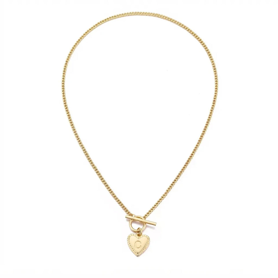A delicate gold chain necklace with a toggle clasp and a small heart-shaped pendant engraved with the letter 'O', displayed on a clean white background.