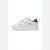 A white children's low-top sneaker with blue accents, featuring two hook-and-loop straps and the 'Hummel' brand name printed in blue on the side, set against a plain white background.