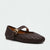 A dark brown woven leather Mary Jane flat shoe with a gold-tone buckle, shown from a three-quarters angle on a light gray background.