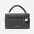 Michael Kors black monogram handbag with a top handle, zippered closure, and a silver padlock charm on a white background.