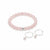 A pink beaded bracelet with a single silver accent bead, displayed alongside a matching pair of silver hoop earrings with small dangling pink beads on a clean white background.