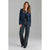 A woman modeling a navy blue cropped blazer with gold buttons, worn over a black top and paired with dark gray wide-leg jeans, against a solid gray studio background.