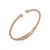 A rose gold open cuff bangle bracelet with pavรฉ-set clear crystals at both ends and an inner clasp engraved with the brand name 'DKNY', shown on a clean white background.