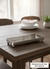 Rectangular silver tray on a wooden table with a blurred background