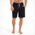 A man wearing black swim shorts with a light gray drawstring, shown from the waist down against a white background.