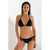 A woman modeling a black two-piece bikini with a halter top and side-tie bottoms against a plain light background.
