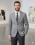 Man wearing a gray suit and tie in an art gallery setting