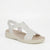 A white wedge sandal with braided and perforated straps, featuring a beige footbed and a thick white platform sole, shown against a plain white background.