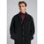 A man wearing a black textured teddy fleece button-up coat over a burgundy turtleneck sweater, photographed against a neutral gray studio background.