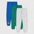 Three pairs of kids' jogger sweatpants in blue, green, and light gray, arranged in a vertical stack on a light gray background. The blue pair features a 'LET'S SKATE' graphic on the lower left leg.