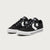 A pair of black low-top sneakers with white star logos and white soles, photographed on a clean light gray background.