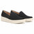 A pair of black slip-on platform sneakers with thick cream-colored soles, shown on a clean white background.