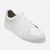 A clean white leather low-top sneaker with white laces and a thick white rubber sole, photographed on a seamless white background.