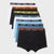 A 5-pack of men's boxer briefs fanned out on a light gray background, featuring black, white, orange, yellow, and blue colors with corresponding weekday elastic bands labeled SUNDAY through MONDAY.