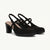 A pair of black slingback mule heels with a block heel, platform sole, and criss-cross ankle straps, shown on a light cream background.