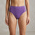A model wearing a pair of high-waisted, solid purple bikini bottoms against a neutral gray textured background.
