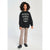 A child model wearing a black crewneck sweatshirt with white 'BEETJUICE' text and skull graphics, paired with beige and brown leopard-print pants and black shoes, standing against a light gray studio background.