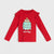 A red long-sleeve children's top with ruffled shoulder details, featuring a cute illustrated Christmas tree graphic and the text 'Get Cozy' printed on the front, displayed against a light gray background.