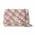 A tweed shoulder bag with a cream, pink, and black plaid pattern, featuring a silver-tone turn-lock clasp and a silver chain strap, shown against a plain white background.