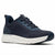A dark navy blue athletic sneaker with a textured knit upper, matching navy laces, a thick white midsole, and a navy protective toe cap, shown from a three-quarters angle on a white background.