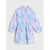 A long-sleeve collared shirt dress with a gathered waist, featuring a pastel purple, light blue, and pink floral pattern, displayed flat against a light gray background.