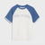 A short-sleeve raglan t-shirt with a white body and blue sleeves, featuring the text 'KEEP IT REAL' arched across the chest in white outlined letters.