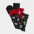 Three pairs of Christmas-themed crew socks arranged in a fan shape on a light gray background. The set includes a solid black pair, a solid red pair, and a dark green pair decorated with gingerbread men, candy canes, and snowflakes.