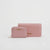 A pink textured leather wallet and matching zip-around card case with gold-tone 'bebe' branding, displayed on a clean white background.