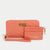 A coral pink quilted wallet set by Bebe The Beauty Box, featuring a large zip-around wallet with a wristlet strap and a smaller card holder with gold-tone hardware and logo.