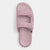 A single light pink slide sandal with quilted strap details and a small tonal logo, shown from a top-down view on a light gray background.
