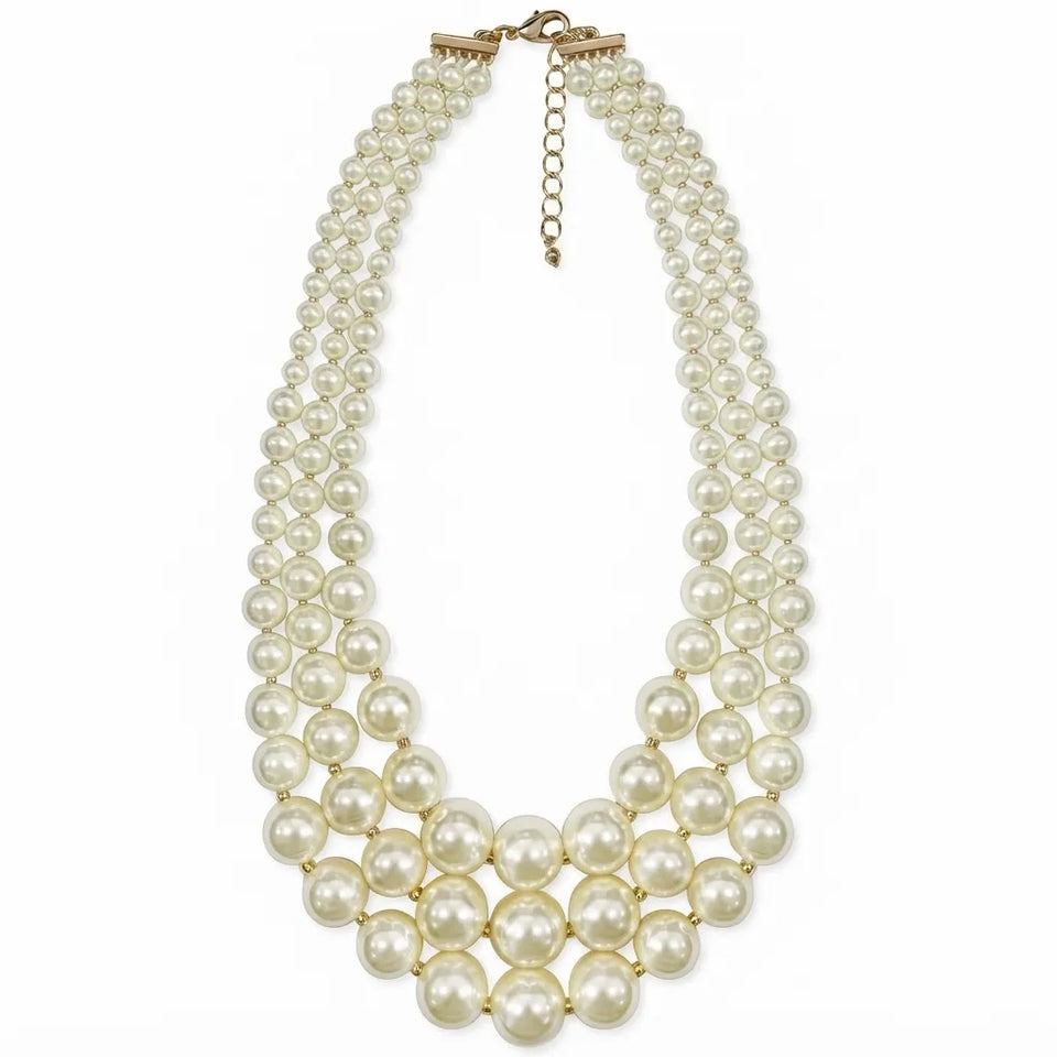 A multi-strand pearl necklace with a gold-tone clasp and extender chain, displayed on a clean white background.