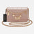 A light pink quilted leather shoulder bag with gold-tone chain detailing, a central interlocking G logo, and a black Bebe brand tag, shown on a light gray background.