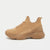 A single tan/beige knit sneaker with a chunky sole, shown in a side profile view against a light gray background. The brand name 'bebe' is embossed on the side.