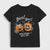 A black short-sleeve kids' t-shirt with a Halloween graphic print featuring two jack-o'-lanterns, spiderwebs, and the text 'BOO! BOO! IN MY SPOOKY VIBES ERA'.