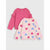Two girls' long-sleeve tops laid flat on a light gray background. The top on the left is solid pink with ruffled shoulder details.