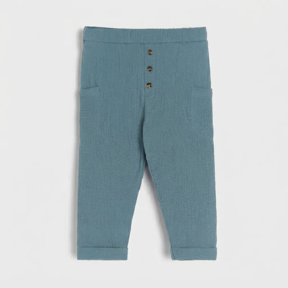 A pair of toddler's blue-gray textured trousers with a button-up front and side pockets, shown flat on a light gray background.