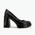 A single black patent leather pump with a chunky block heel and platform sole, shown in profile against a plain white background.