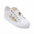 A white leather low-top sneaker featuring decorative gold and silver flower embellishments on the side, gold metal eyelets, and a beige heel tab, shown on a plain white background.