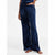 A person wearing dark navy blue velvet lounge pants with a matching top, shown from the waist down against a plain white studio background.