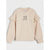 A light beige long-sleeve sweatshirt with ruffled details on the shoulders and sleeves, featuring a small black embroidered graphic of flowers and the text 'flower girl' on the chest, displayed against a light gray background.