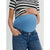 A close-up of a pregnant person wearing a light blue maternity belly band over blue jeans, paired with a black and white striped top.