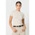 A woman modeling a beige short-sleeve crewneck t-shirt tucked into beige pants with a black belt, against a light gray studio background.